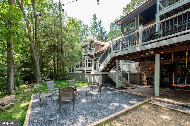 view of patio with a deck and an outdoor fire pit