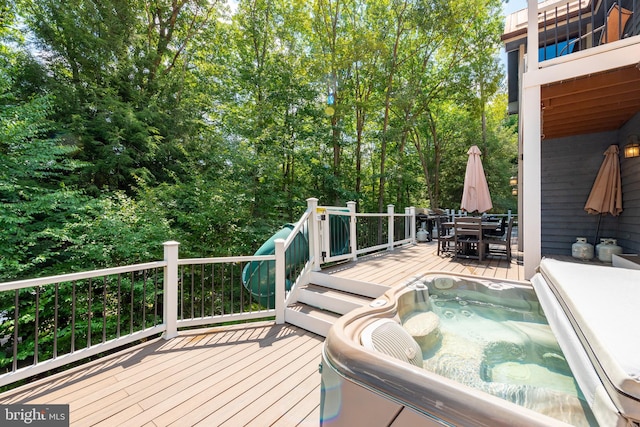 wooden terrace with an outdoor hot tub