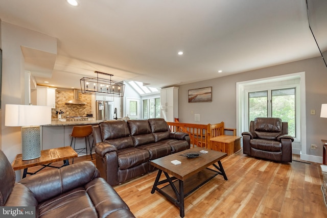 living room featuring an inviting chandelier and light hardwood / wood-style flooring