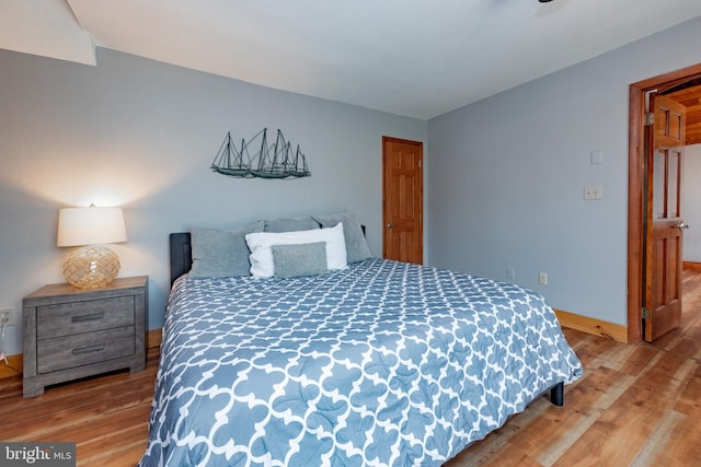 bedroom with hardwood / wood-style floors