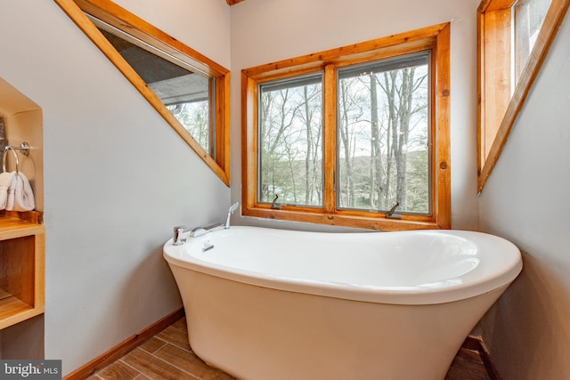 bathroom with hardwood / wood-style flooring and a tub