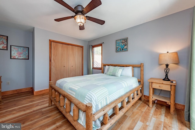 bedroom featuring ceiling fan, light hardwood / wood-style flooring, and a closet