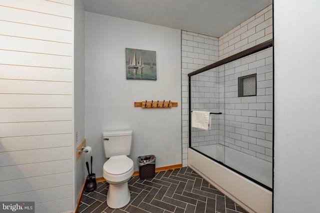 bathroom with tile patterned flooring, toilet, and enclosed tub / shower combo