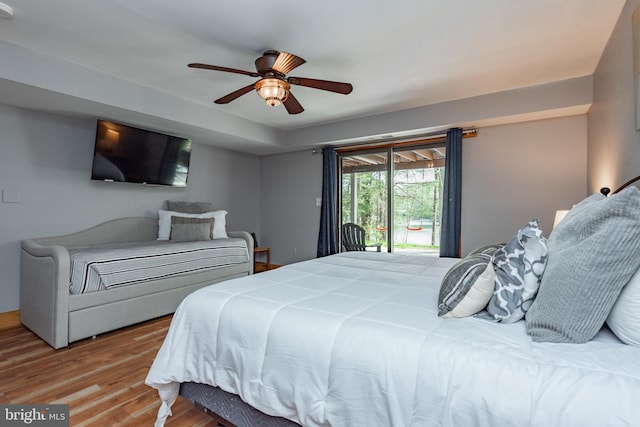 bedroom featuring access to exterior, ceiling fan, and wood-type flooring