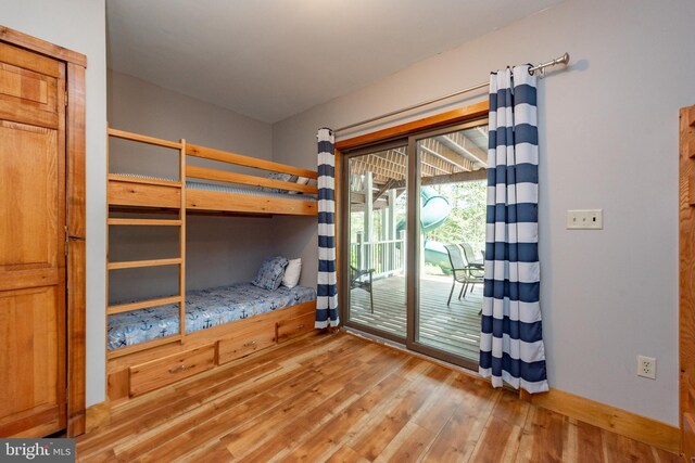 unfurnished bedroom featuring wood-type flooring and access to outside