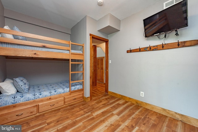 unfurnished bedroom with hardwood / wood-style floors