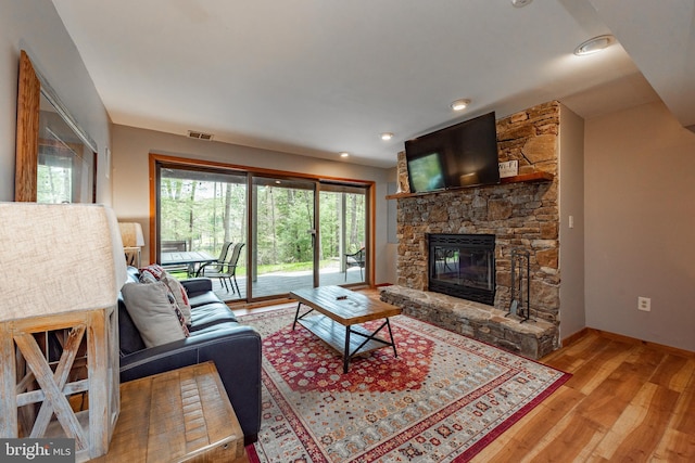 living room with light hardwood / wood-style floors and a fireplace