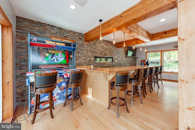 bar with butcher block countertops, pendant lighting, beam ceiling, and light hardwood / wood-style floors