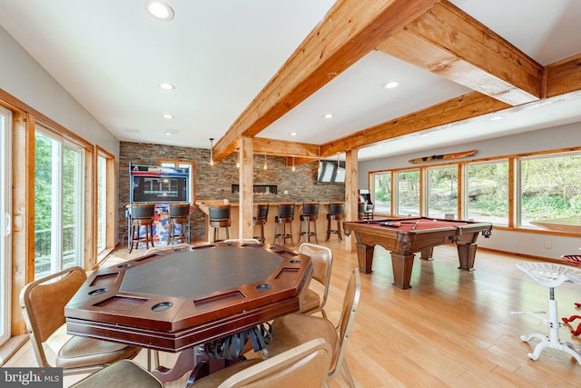 rec room featuring beamed ceiling, light hardwood / wood-style floors, indoor bar, and pool table