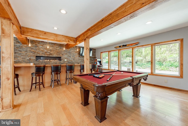 recreation room with beamed ceiling, light wood-type flooring, indoor bar, and billiards