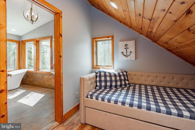 bedroom featuring a chandelier, light wood-type flooring, lofted ceiling, and wood ceiling