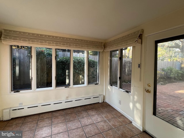 unfurnished sunroom featuring a baseboard heating unit