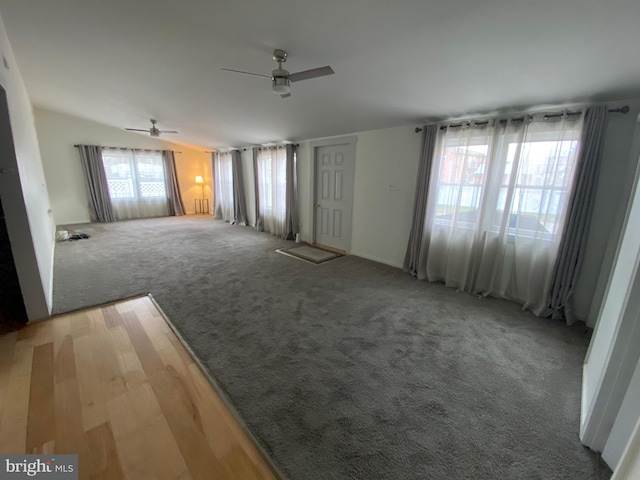 unfurnished living room featuring carpet flooring and ceiling fan