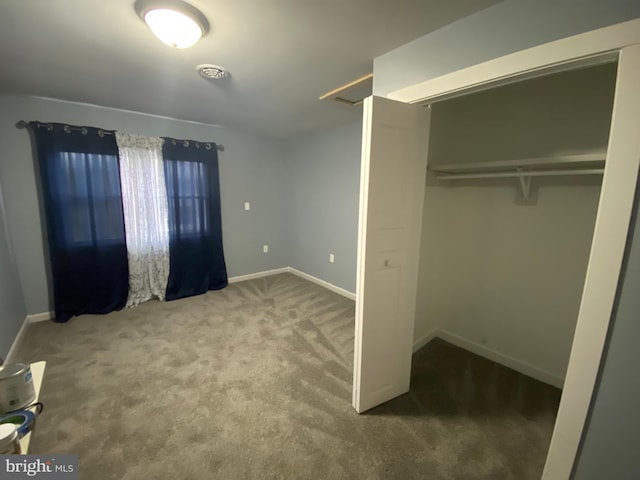 unfurnished bedroom featuring a closet and carpet floors