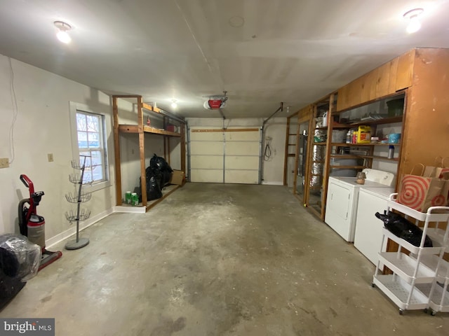 garage with separate washer and dryer and a garage door opener