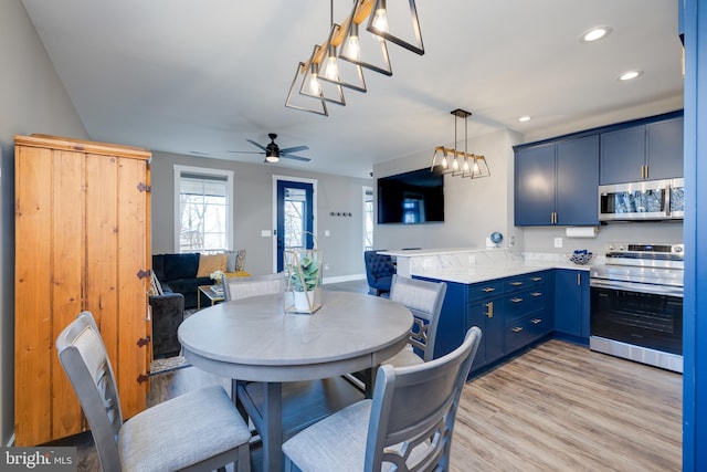 dining area featuring ceiling fan and light hardwood / wood-style flooring