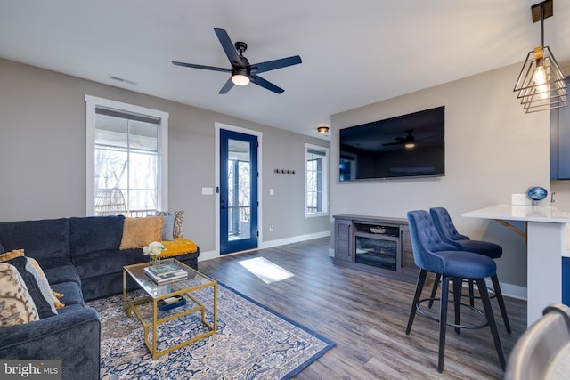 living room featuring hardwood / wood-style flooring and ceiling fan