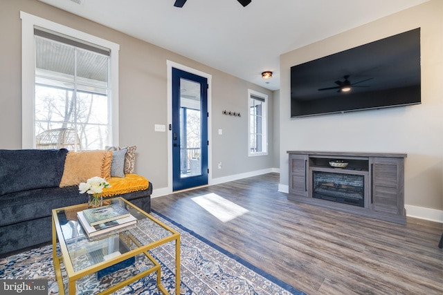 living room featuring hardwood / wood-style floors, plenty of natural light, and ceiling fan