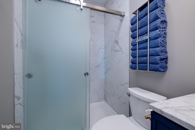 bathroom featuring vanity, toilet, and a shower with door