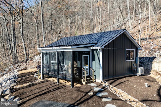 view of outbuilding with a sunroom