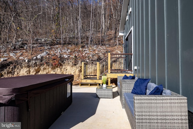 view of patio / terrace featuring an outdoor hangout area and a hot tub