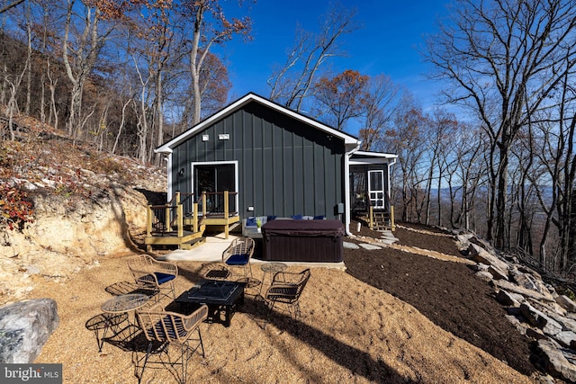 exterior space featuring a hot tub and a deck