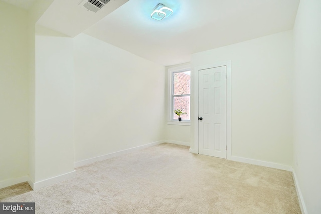 empty room featuring light carpet