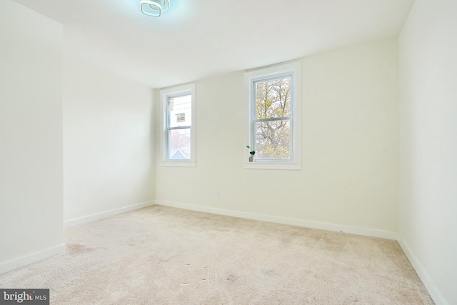 empty room featuring light carpet