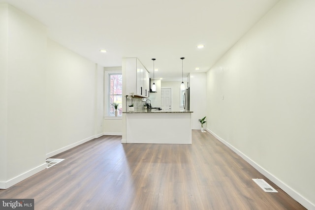 unfurnished living room with dark hardwood / wood-style floors