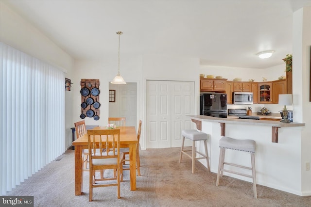 dining room with light carpet