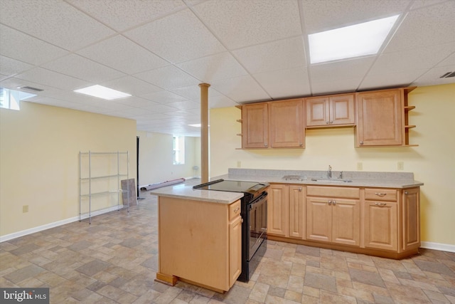 kitchen featuring electric range, plenty of natural light, sink, and light brown cabinetry