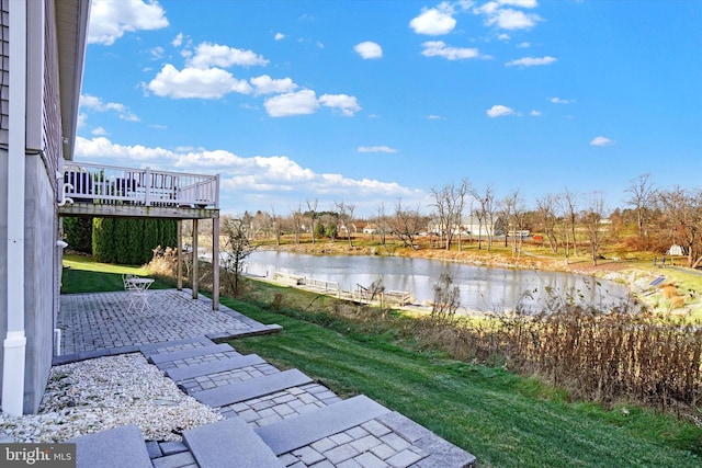 view of yard with a deck with water view and a patio area