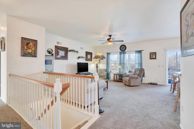 carpeted living room with ceiling fan