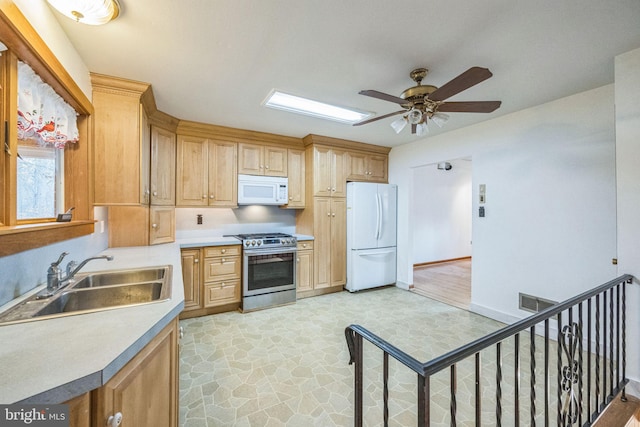 kitchen with ceiling fan, light wood-type flooring, white appliances, and sink