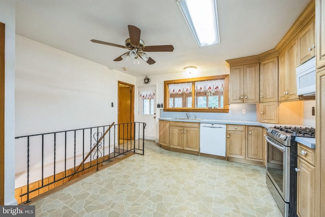 kitchen featuring ceiling fan, sink, and white appliances