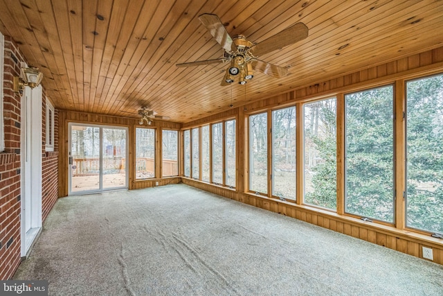 unfurnished sunroom with ceiling fan, plenty of natural light, and wooden ceiling