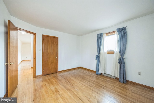 unfurnished bedroom with light wood-type flooring