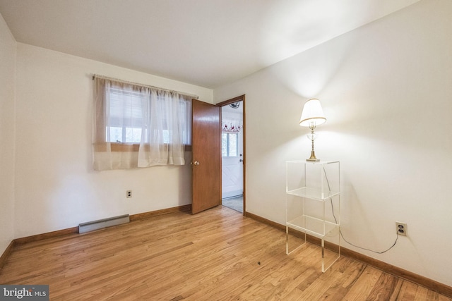 unfurnished room with plenty of natural light and light hardwood / wood-style floors