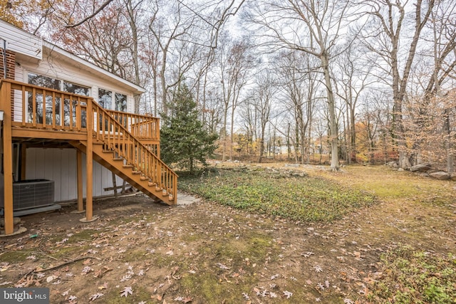 view of yard featuring cooling unit and a deck