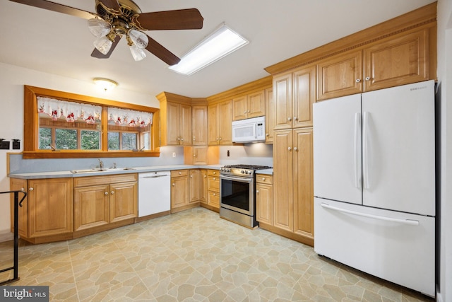 kitchen with ceiling fan, sink, and white appliances