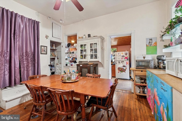 dining area featuring ceiling fan and dark hardwood / wood-style flooring