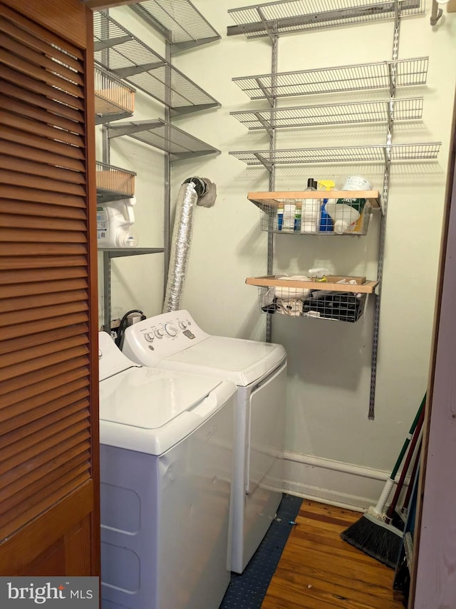 laundry room featuring separate washer and dryer and dark hardwood / wood-style floors