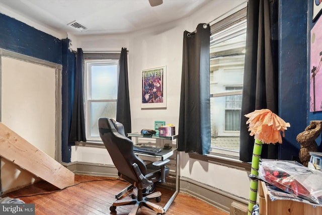 home office with hardwood / wood-style flooring