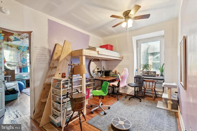 interior space with hardwood / wood-style floors and ceiling fan