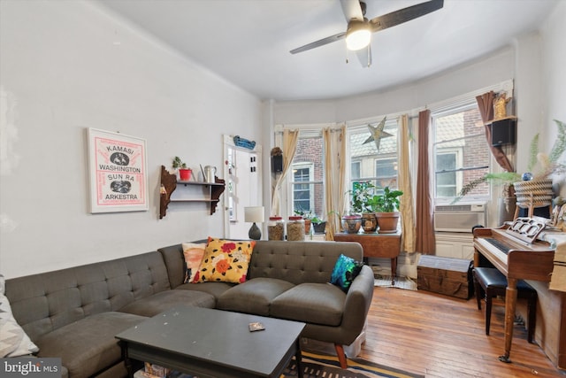 living room featuring hardwood / wood-style floors, cooling unit, and ceiling fan