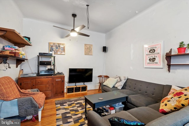 living room featuring wood-type flooring and ceiling fan