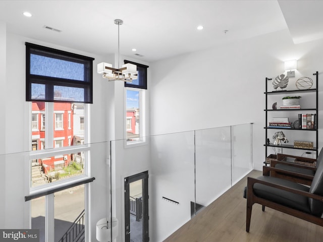 interior space with a chandelier and hardwood / wood-style flooring