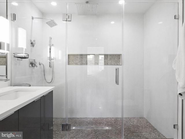 bathroom featuring vanity and an enclosed shower