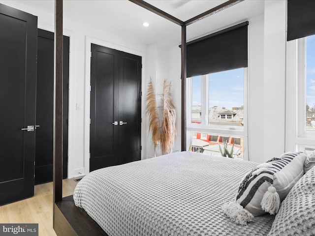 bedroom featuring light hardwood / wood-style floors and multiple windows