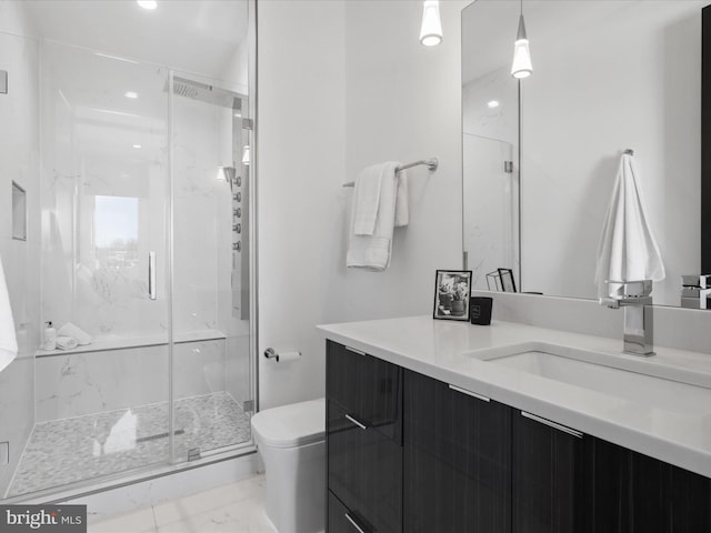 bathroom featuring vanity, toilet, and an enclosed shower